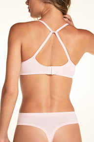 On a light studio backdrop, Alexis wears the Cloud Cotton T-Shirt Bra in Dogwood paired with matching underwear. The back view showcases the adjustable straps, hook-and-eye closure, and smooth back band.