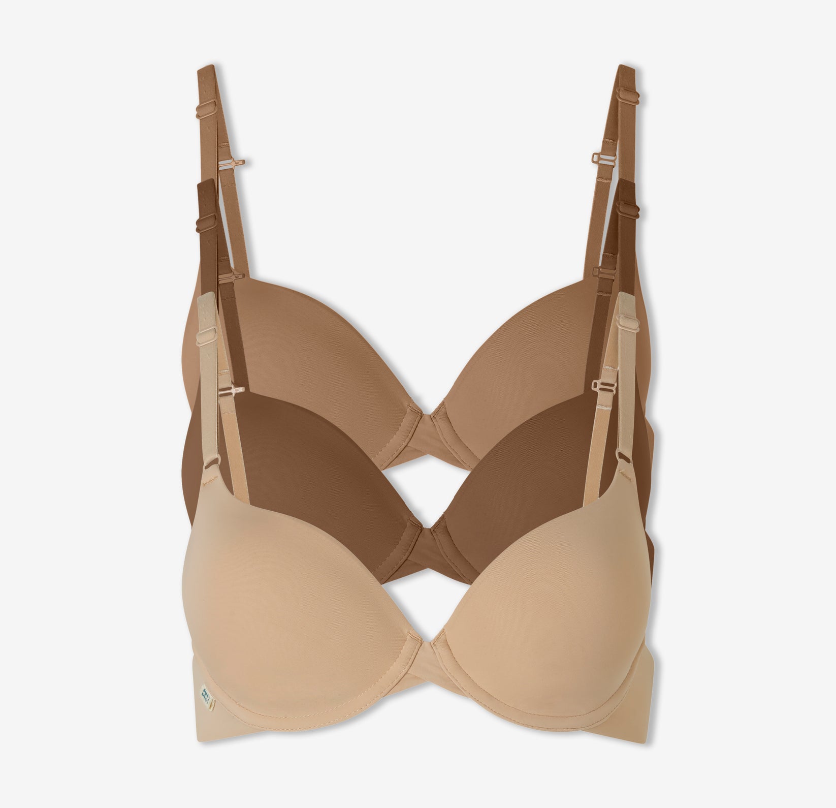 A trio of Harper Wilde's Base T-Shirt Bras in Tan, Brown, and Beige against a white background.