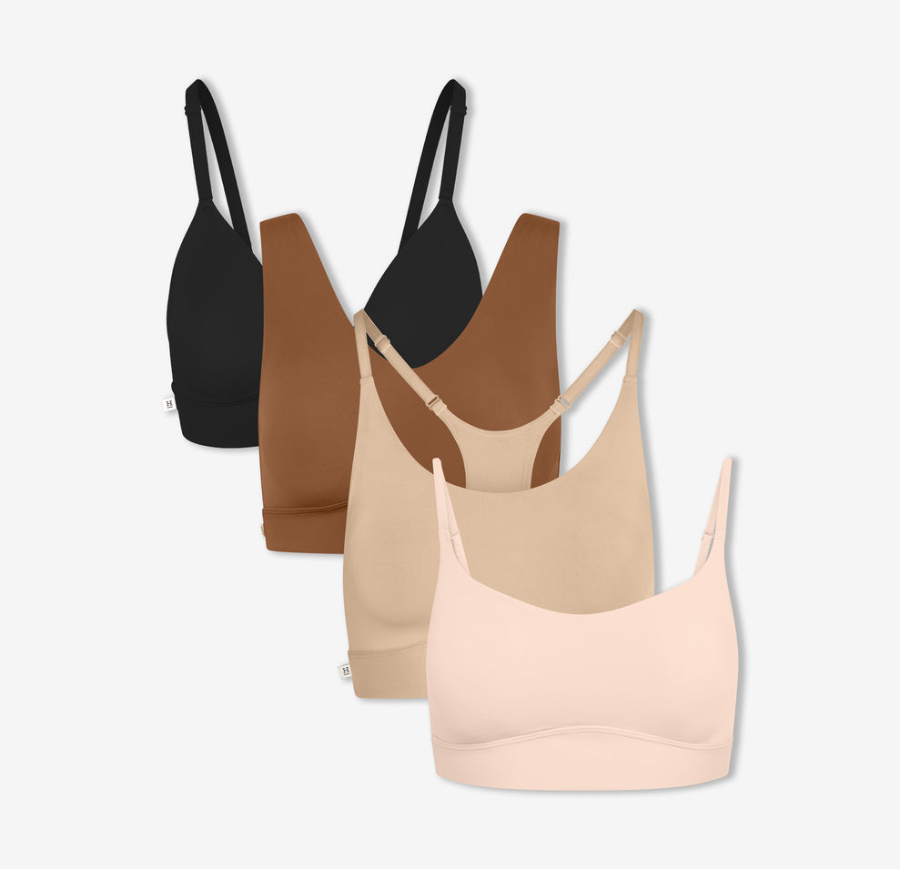 Harper Wilde's Bliss Triangle Bralette in Black, Bliss Bralette in Brown, Bliss Racerback Bralette in Beige, and Bliss Scoop Bralette in Rose against a white background. 