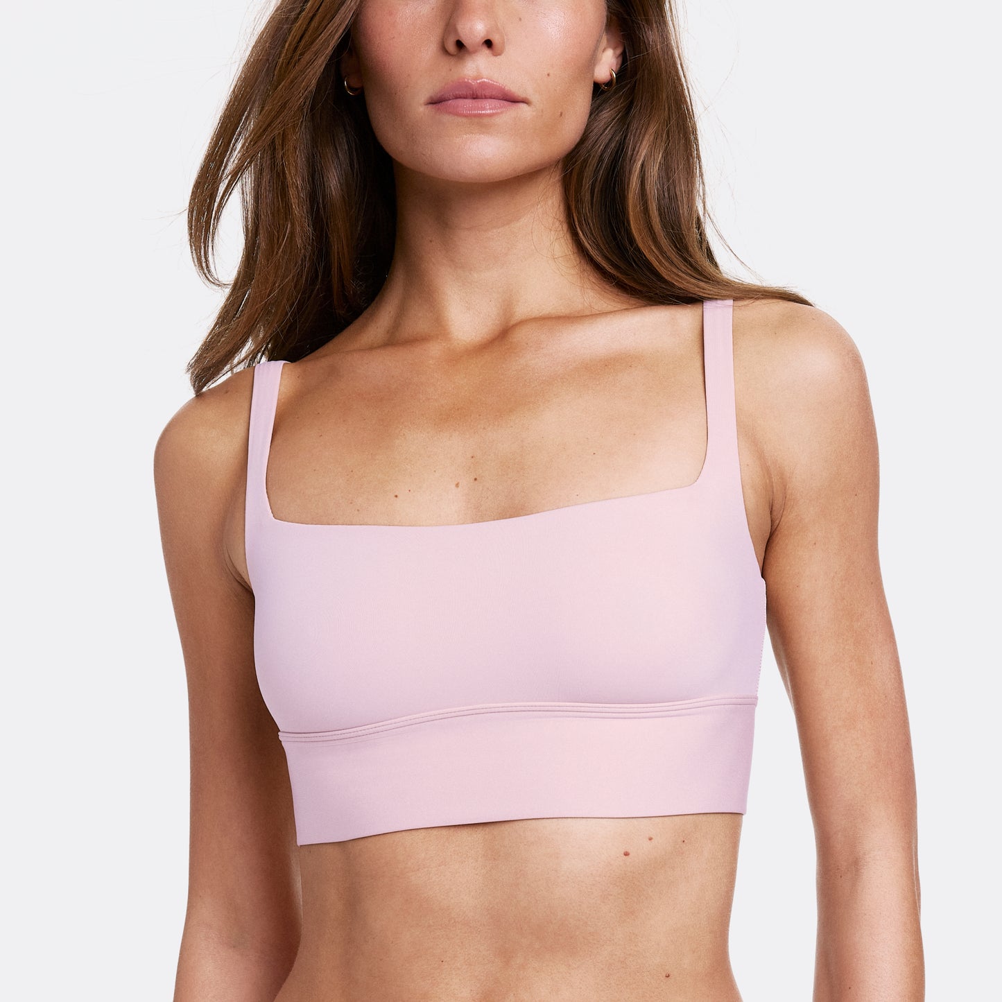 In a studio setting with a light gray backdrop, Gianna wears the Bliss Square Neck Bralette in Retro Lilac, highlighting the square neckline and longline silhouette. The bralette features thin adjustable straps and a soft wireless band, made from smooth microfiber fabric for all-day comfort.