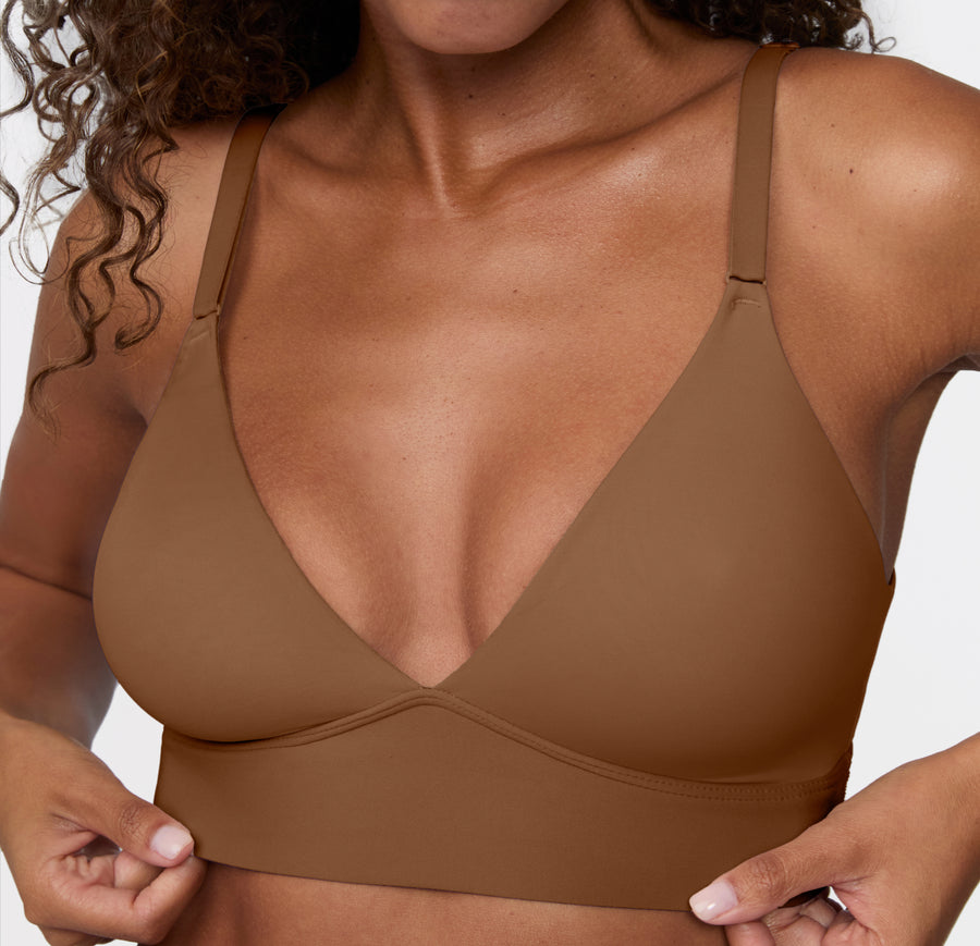 Model wearing the Harper Wilde Bliss Triangle Bralette in Brown — wire-free triangle bralette with deep V-neckline, adjustable straps, and wide underband.