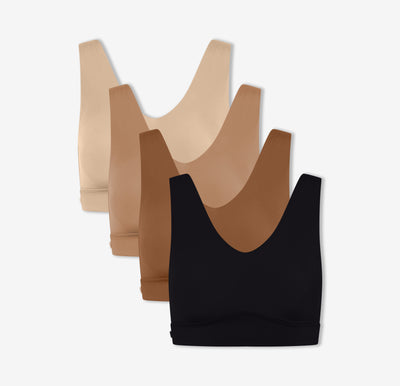 Four of Harper Wilde's Bliss Bralettes in Black, Brown, Tan, and Beige which offer ultra-soft wireless support and comfort against a white background.