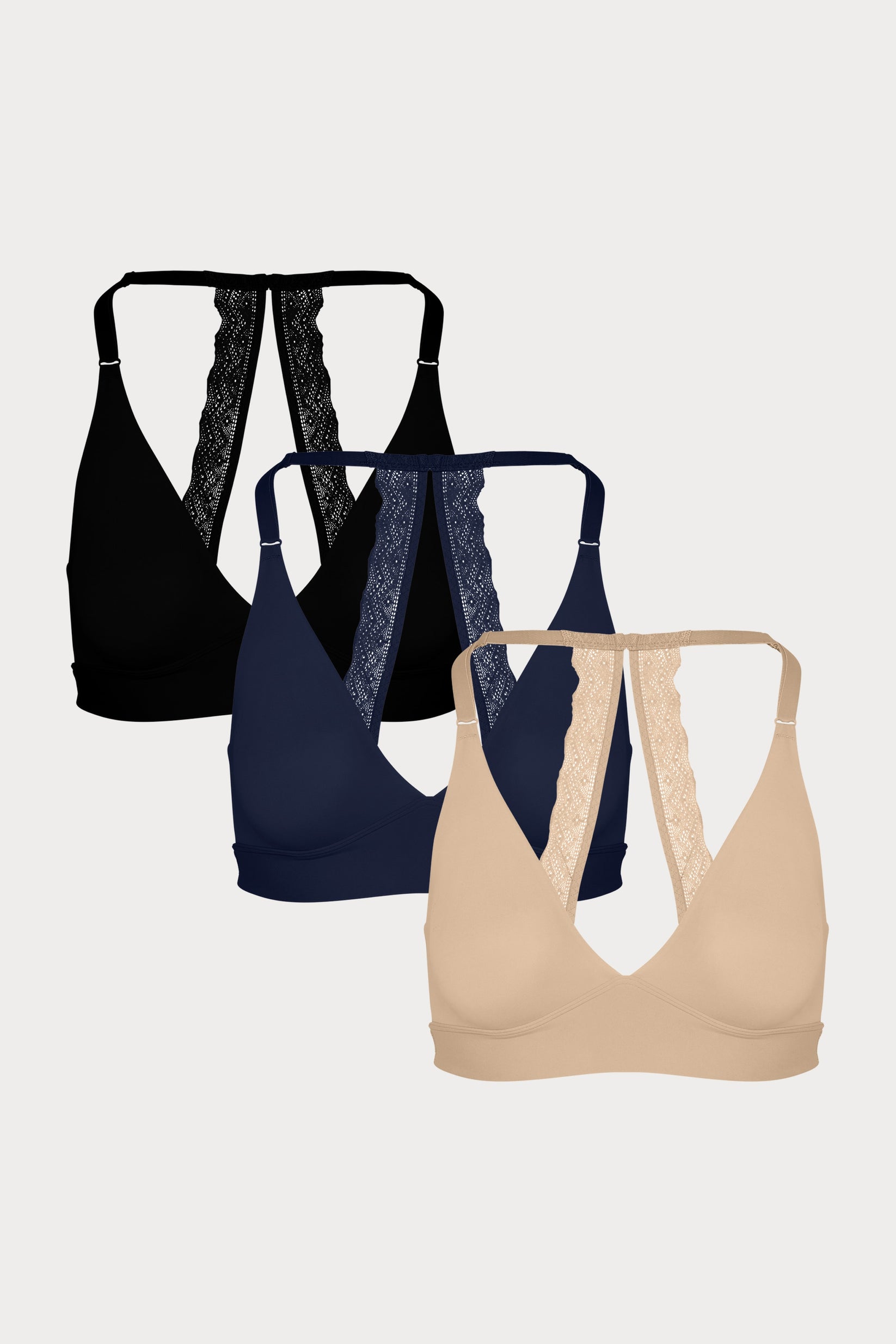 Three Bliss Lace Halterneck Bralettes in Black, Navy, and Beige displayed on a light grey background, highlighting the signature lace back detail.