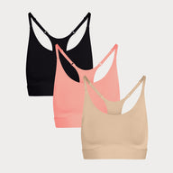 Three Bliss Racerback Bralettes in Black, Cabana, and Beige displayed on a light grey background, showing the adjustable racerback straps.