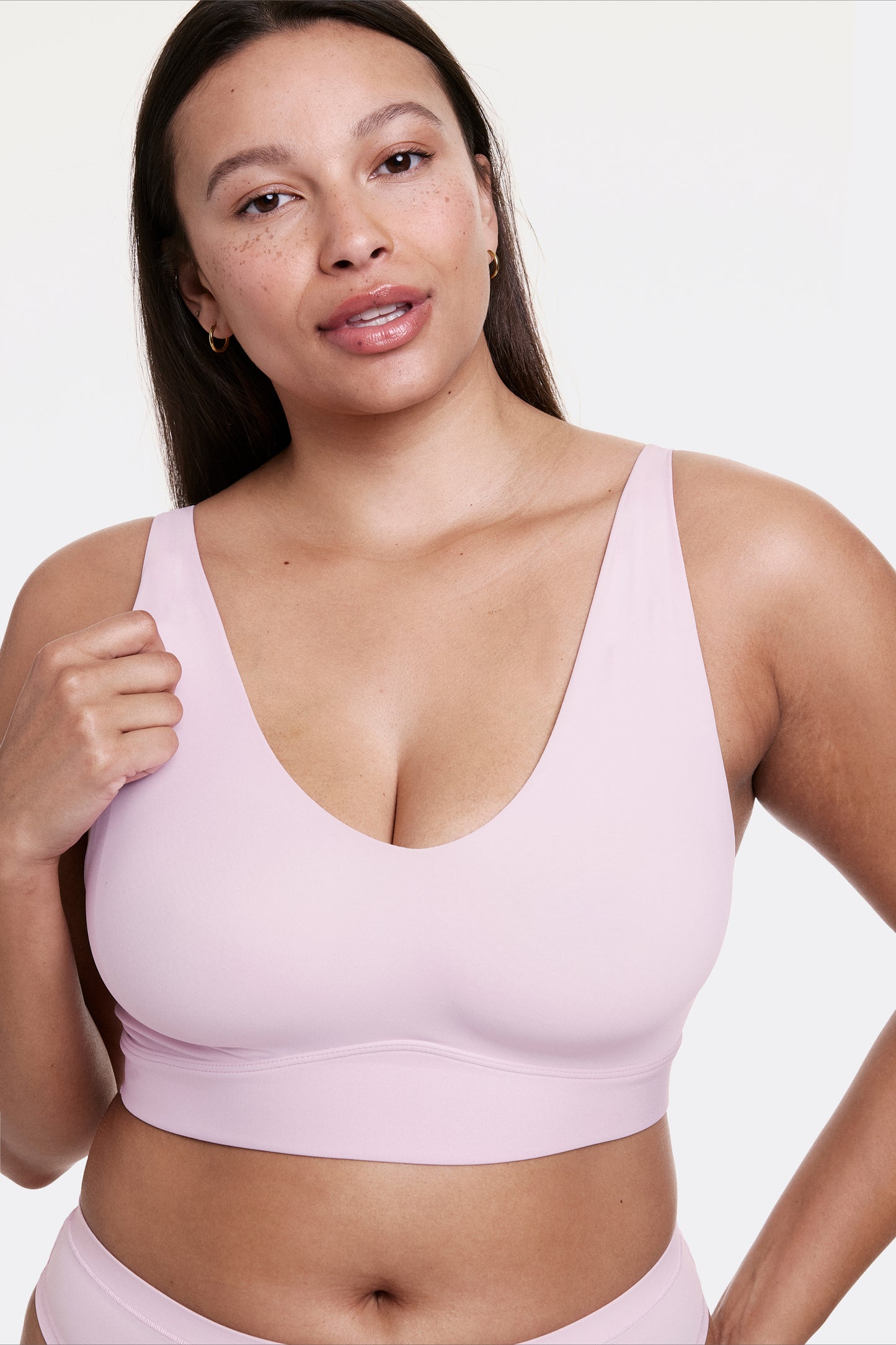 Close-up of Alana wearing a seamless V-neck bralette in Retro Lilac, showing a smooth, wireless fit and wide straps for comfort.