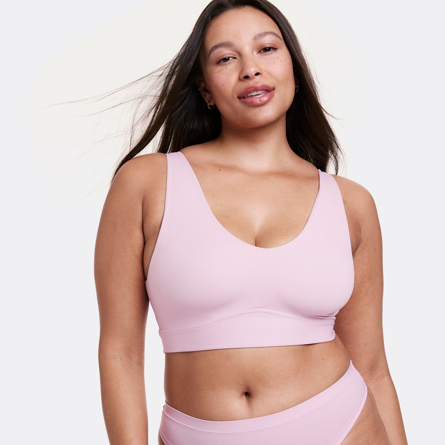 Alana wearing a Retro Lilac seamless bralette and matching underwear, featuring a V-neckline, soft stretch fabric, and a supportive underband.