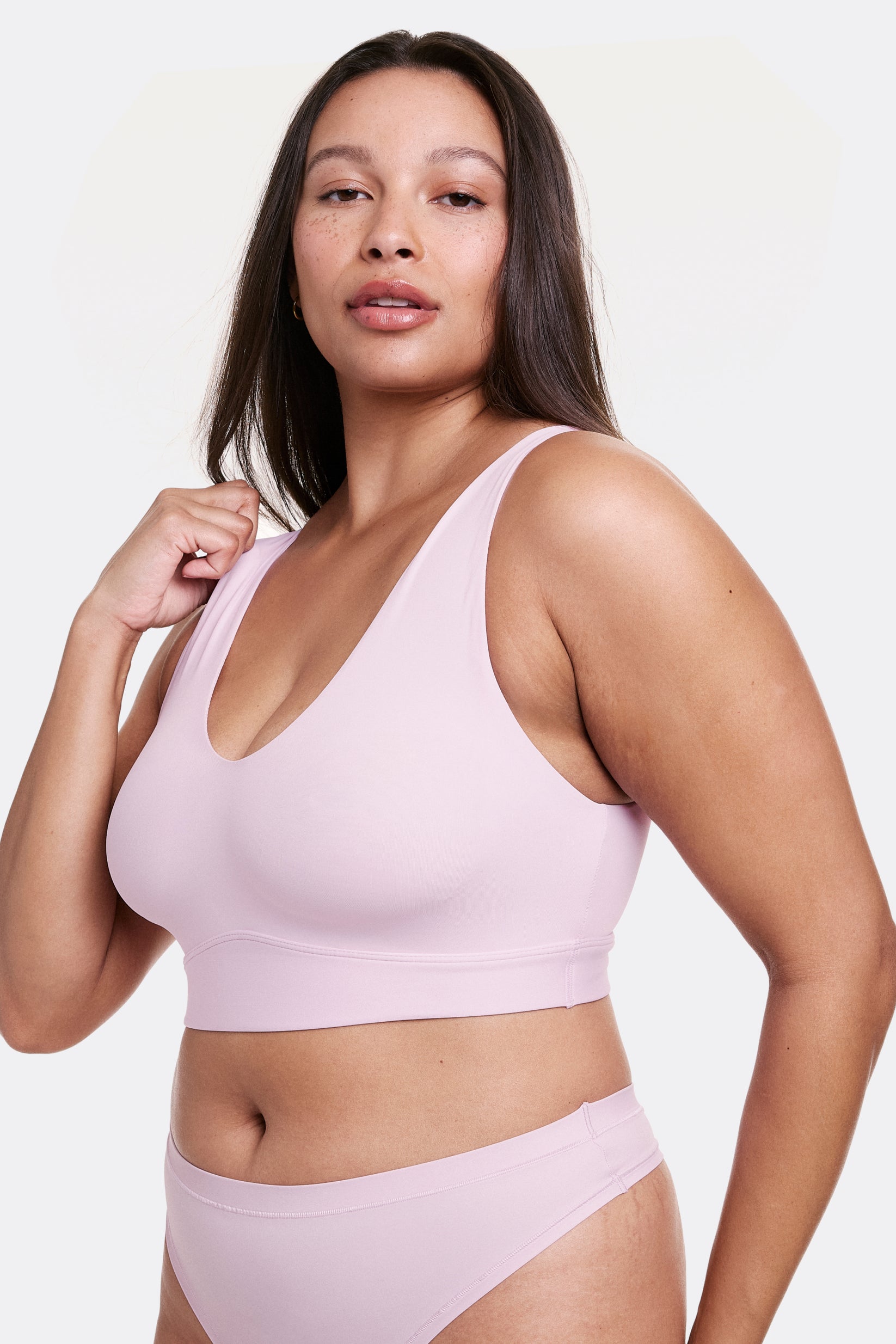 Angled view of Alana wearing a Retro Lilac V-neck bralette with wide straps and a seamless construction, paired with matching underwear. sizing: Alana is wearing size Large