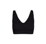 Flatlay of the Bliss Bralette – Sleek Lined in Black. The bralette features a deep scoop neckline, wide straps, and smooth, molded cups with a minimalist, no-seam finish. Displayed against a white background.
