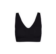 Flatlay of the Bliss Bralette – Sleek Lined in Black. The bralette features a deep scoop neckline, wide straps, and smooth, molded cups with a minimalist, no-seam finish. Displayed against a white background.