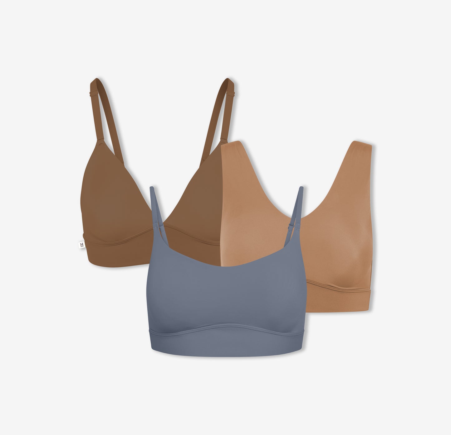 A trio of Harper Wilde's Bliss Triangle Bralette in Brown, Bliss Bralette in Tan, and Bliss Scoop Bralette in Steel which offers ultra-soft wireless support and comfort.