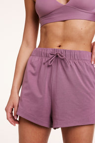 In a studio setting, Gianna wears Cloud Cotton shorts in Mirage, featuring a soft elastic waistband with adjustable drawstring and lightweight, breathable fabric. sizing: Gianna wears size Small