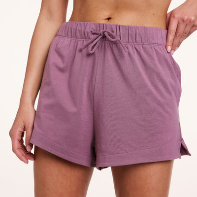 In a studio setting, Gianna wears Cloud Cotton shorts in Mirage, highlighting the elastic waistband with drawstring and smooth, drapey fabric.