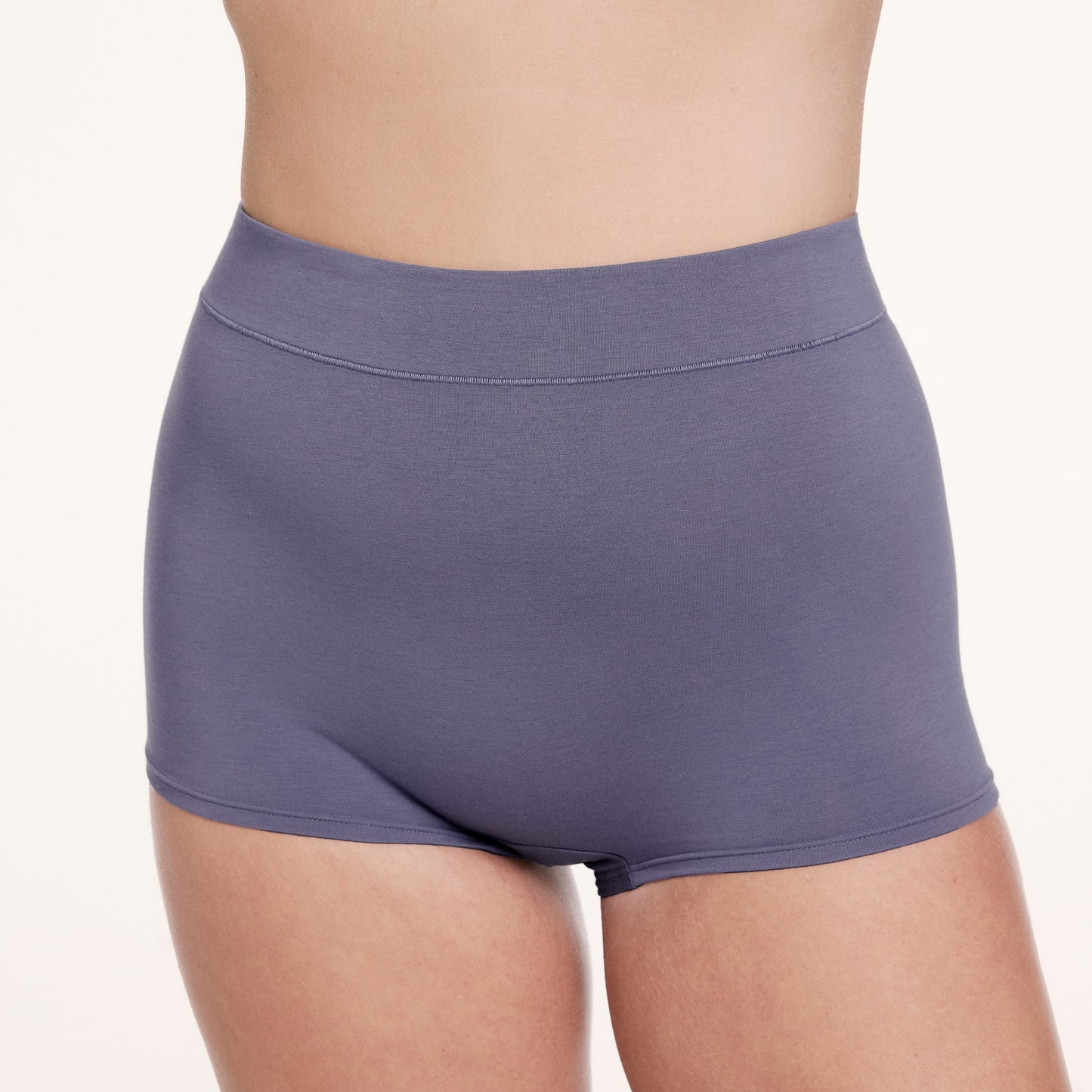 On a white studio backdrop, Sonnie wears the Cloud Cotton Boyshort in Slate, shown from the front with a high-rise fit and full coverage in soft, breathable cotton modal fabric.