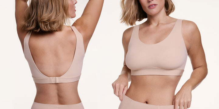 In a studio setting, a model wears the Bliss Scoop Bralette in a soft beige tone, shown from the front with a scoop neckline and wide straps, while a back view reveals the scoop back and hook-and-eye closure. The smooth microfiber fabric and wireless band provide soft support and all-day comfort.
