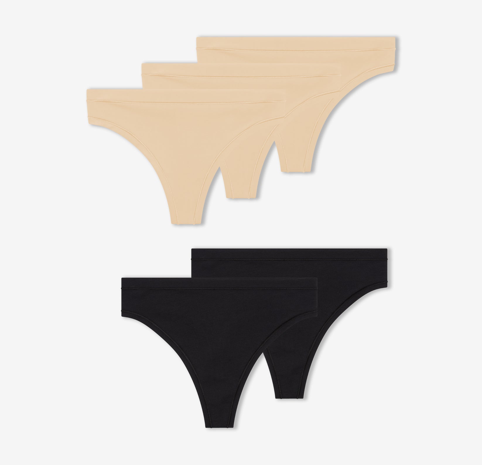 A trio of Harper Wilde's Bliss Thongs in Beige and a duo of Cloud Cotton Highwaist Thongs in Black against a white background.