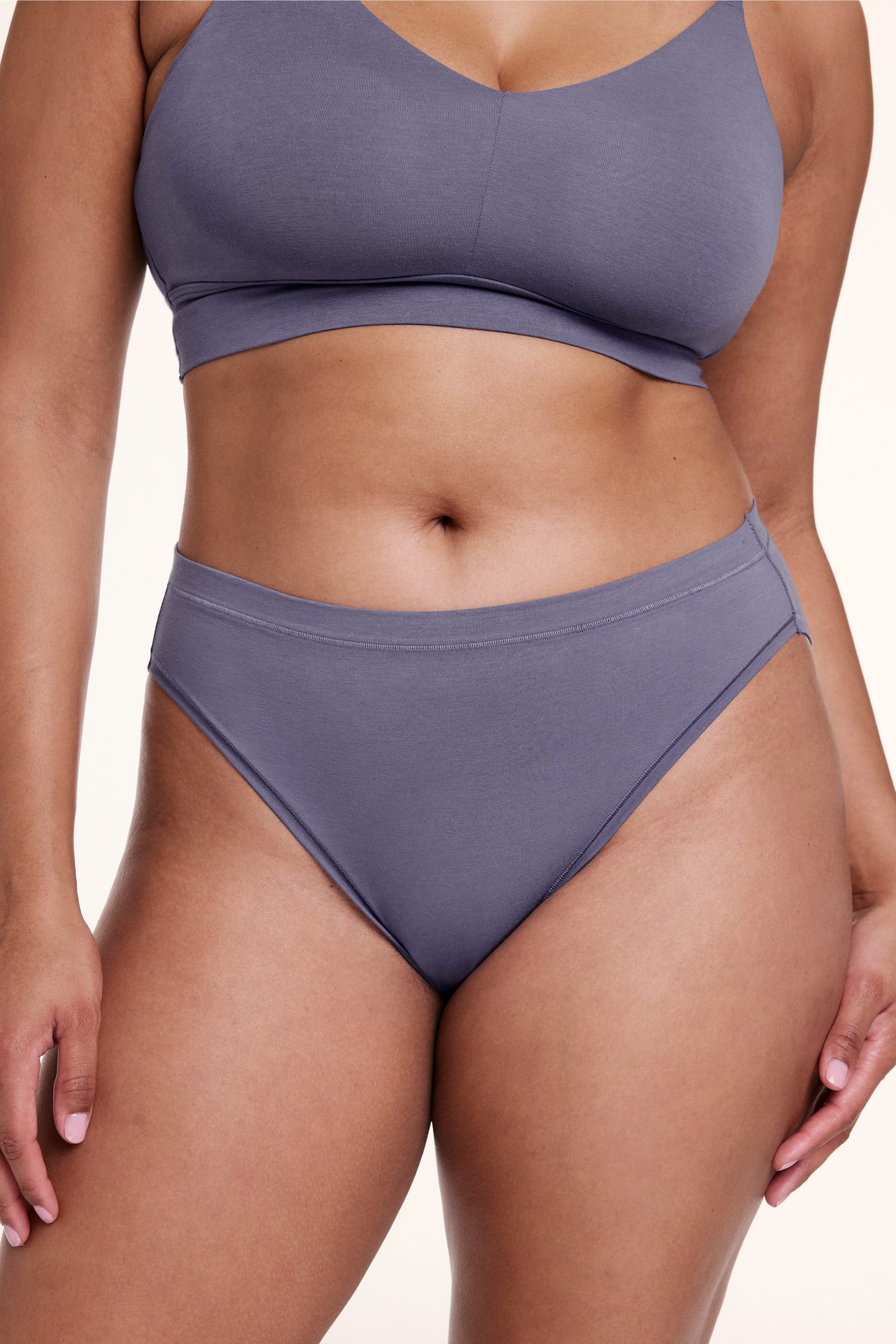 On a white studio backdrop, Alana wears the Cloud Cotton French Cut Brief in Slate, shown from the front with a high-rise waist and French cut leg opening. sizing: Alana wears size Large