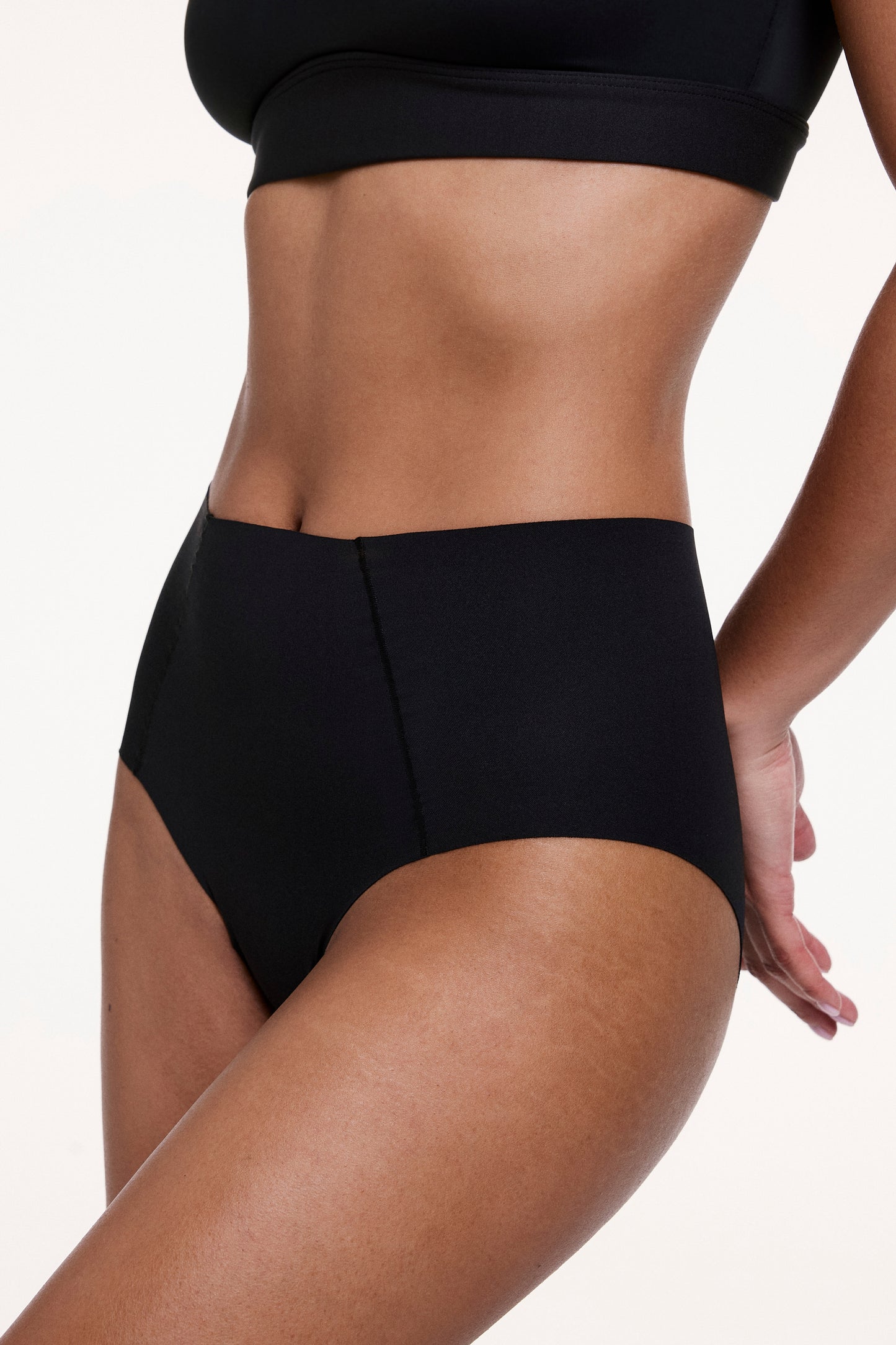Angled front view of the No-Show High Waist Brief in Black, highlighting the high-rise fit, soft stretch fabric, and seamless construction.
