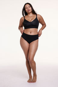 Full-body view of Alana wearing the No-Show High Waist Thong in Black with a matching bra, highlighting the smooth fit and no-show design.