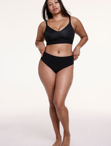 Full-body view of Alana wearing the No-Show High Waist Thong in Black with a matching bra, highlighting the smooth fit and no-show design.
