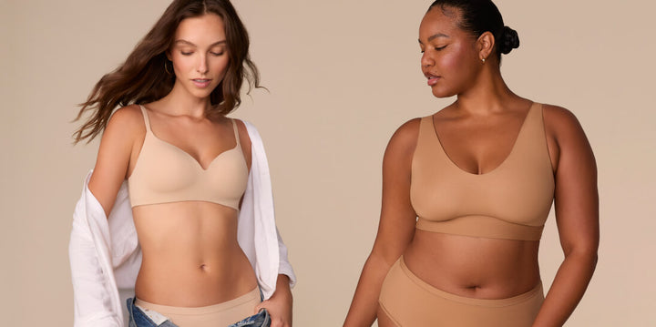 Two models wearing Harper Wilde nude-toned bras: on the left, the Base Wireless Bra in beige paired with a white button-down shirt and briefs; on the right, the Bliss Bralette in tan styled with matching high-waisted briefs.