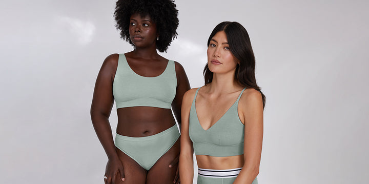 Akesha and Anna wearing the Harper Wilde Cloud Cotton collection in Seaglass. Akesha wears the Cloud Cotton Scoop Bralette with matching underwear, while Anna pairs the Cloud Cotton Triangle Bralette with the Retro Boxer for a relaxed, effortless look. The soft green hue and breathable fabric highlight everyday comfort and style.