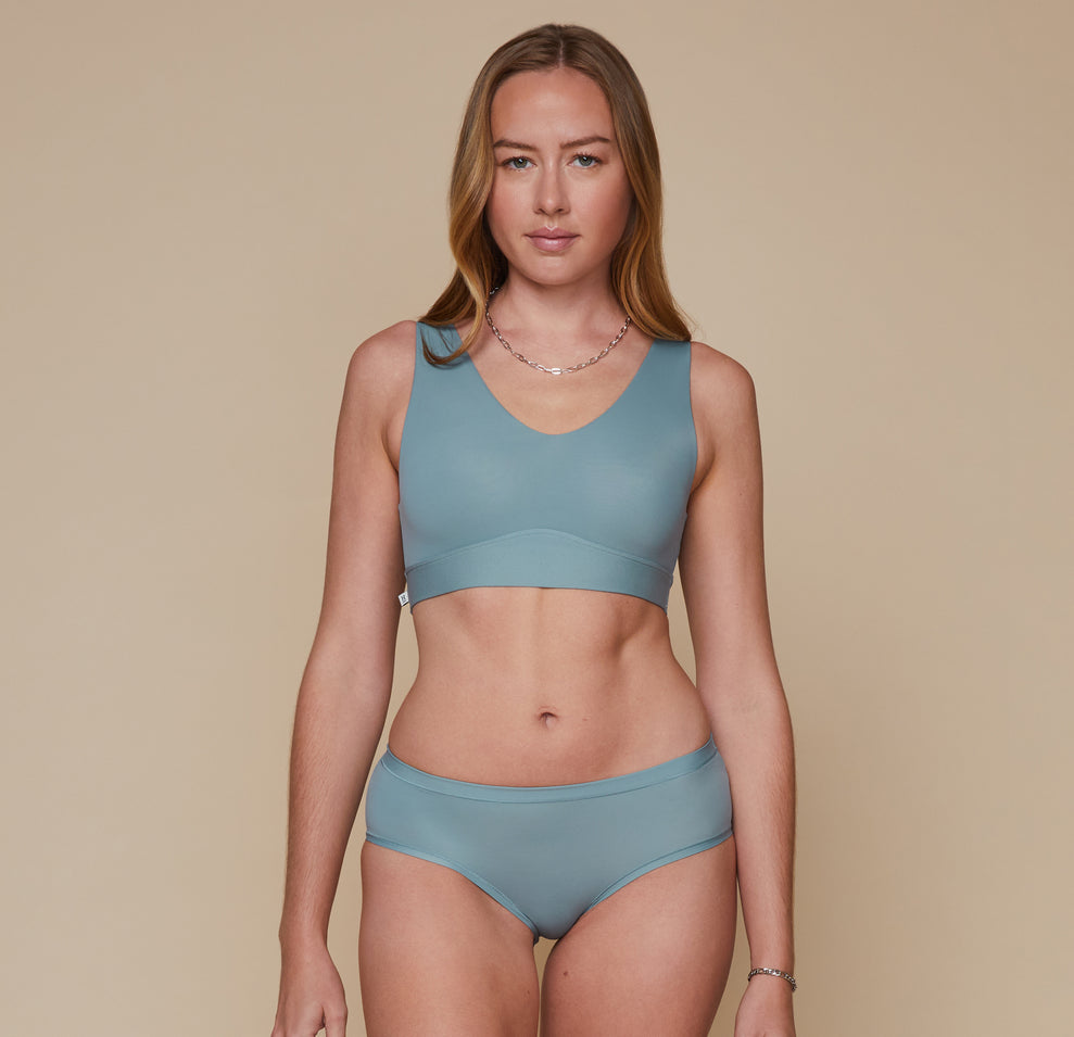 Model wearing the Bliss Bralette and the Bliss Hiphugger in the color Mist. sizing:Erin wears size Small