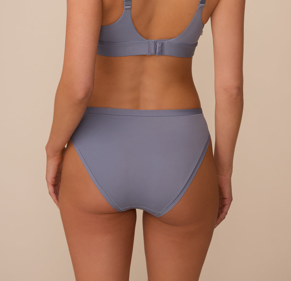 Back view of Marcela wearing the Bliss Bikini in Steel. The full coverage back and comfortable seams are emphasized.