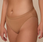 Close up shot of Sonnie in the Bliss Bikini in Tan. The soft microfiber material is emphasized.