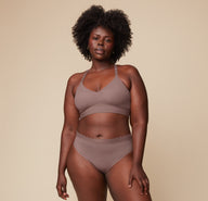 Model Akesha wearing the Bliss Lace Highwaist Brief in Mauve, paired with the matching Bliss Lace Halterneck Bralette. She stands facing forward, highlighting the comfortable, full-coverage fit of the highwaist brief and the supportive bralette.