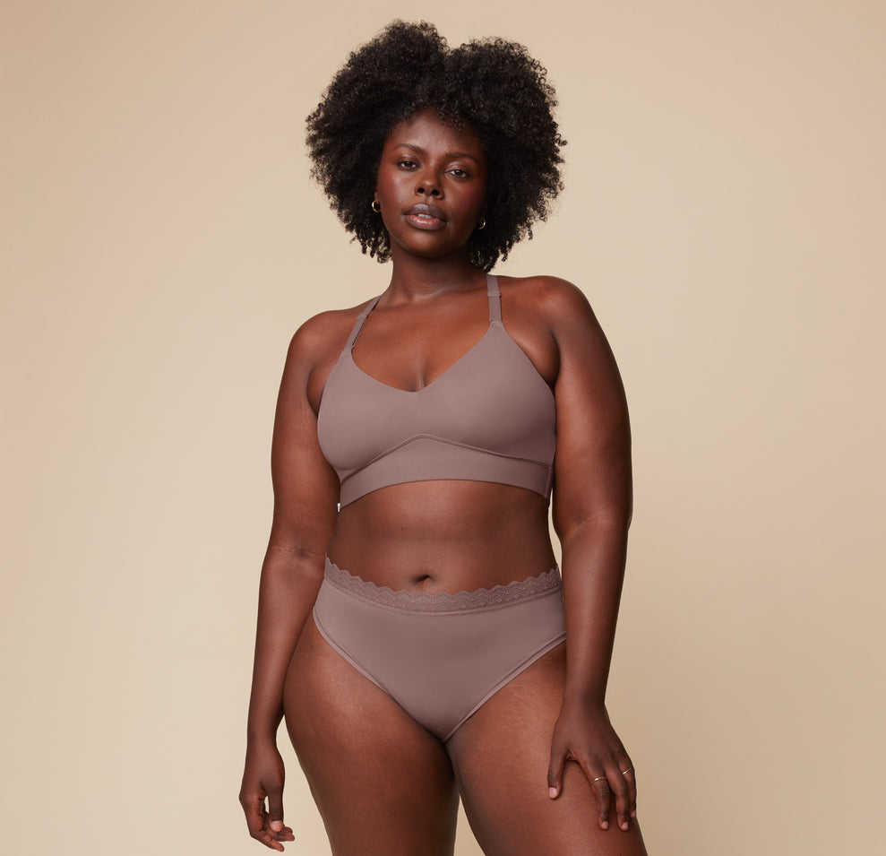 Model Akesha wearing the Bliss Lace Highwaist Brief in Mauve, paired with the matching Bliss Lace Halterneck Bralette. She stands facing forward, highlighting the comfortable, full-coverage fit of the highwaist brief and the supportive bralette.
