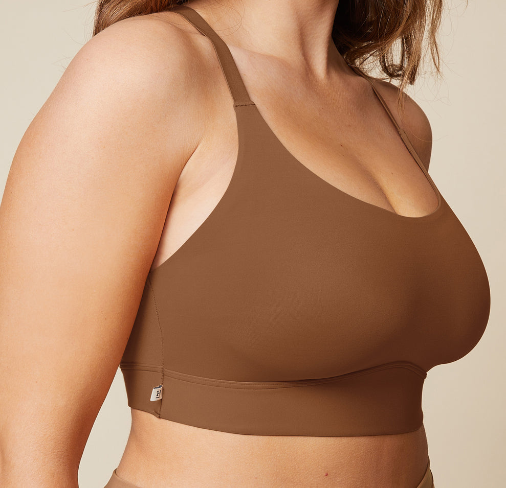 A close-up side view of the Bliss Racerback Bralette in Brown, worn by Summerlyn. The image focuses on the soft fabric and the comfortable fit of the bralette.