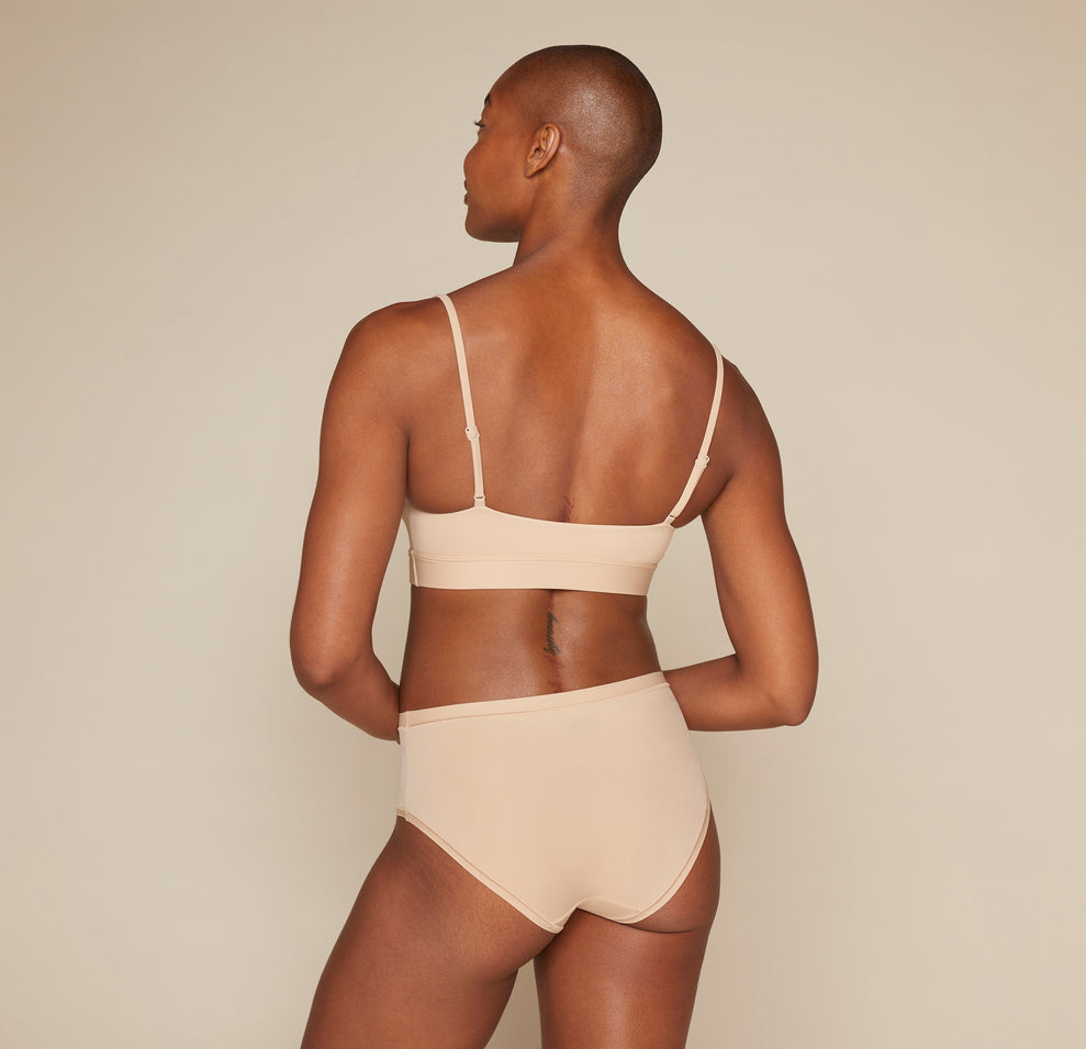 Woman wearing the Bliss Scoop Bralette in the color Beige 