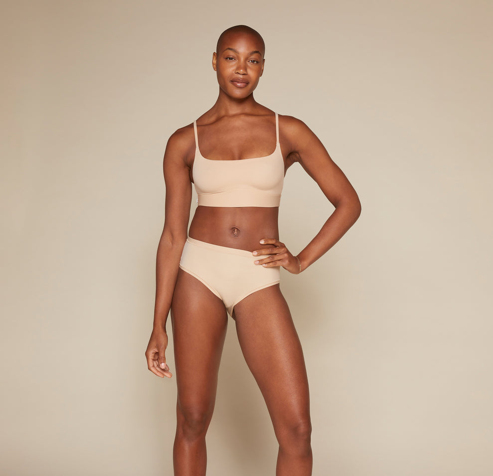 Woman wearing the Bliss Scoop Bralette in the color Beige