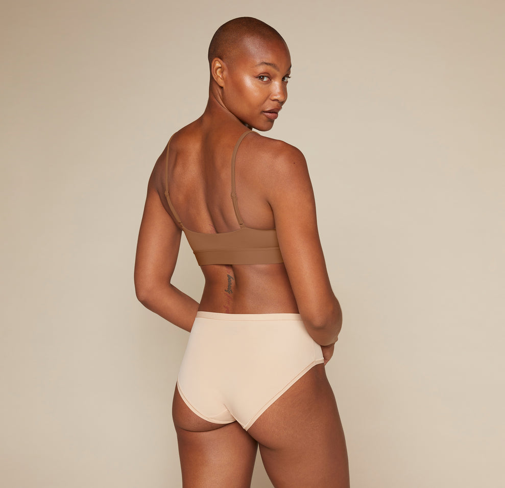 Woman wearing the Bliss Scoop Bralette in the color Brown