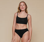 Model wearing the Bliss Scoop Bralette in the color Black. sizing:Erin wears size Small