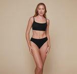 Model wearing the Bliss Scoop Bralette in the color Black.