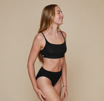 Model wearing the Bliss Scoop Bralette in the color Black.