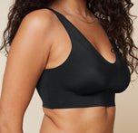 Close-up of Naisha wearing the Bliss Sleek Lined Bralette in Black, focusing on the seamless, wireless design that offers lift without underwire.
