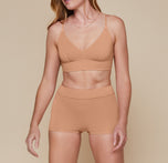 Model wearing the Cloud Cotton Triangle Bralette and matching Highwaist Cloud Cotton Boyshort in the color Dune.