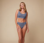 Full-body view of the model standing confidently in the Cloud Cotton Scoop Bralette and matching bottom in Slate. Her hands are relaxed by her sides, set against a simple backdrop.