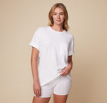 Model Megan wearing the Cloud Cotton Tee in White and the Cloud Cotton Logo Boxer Brief in White, with a relaxed fit and hands casually resting on her hips.