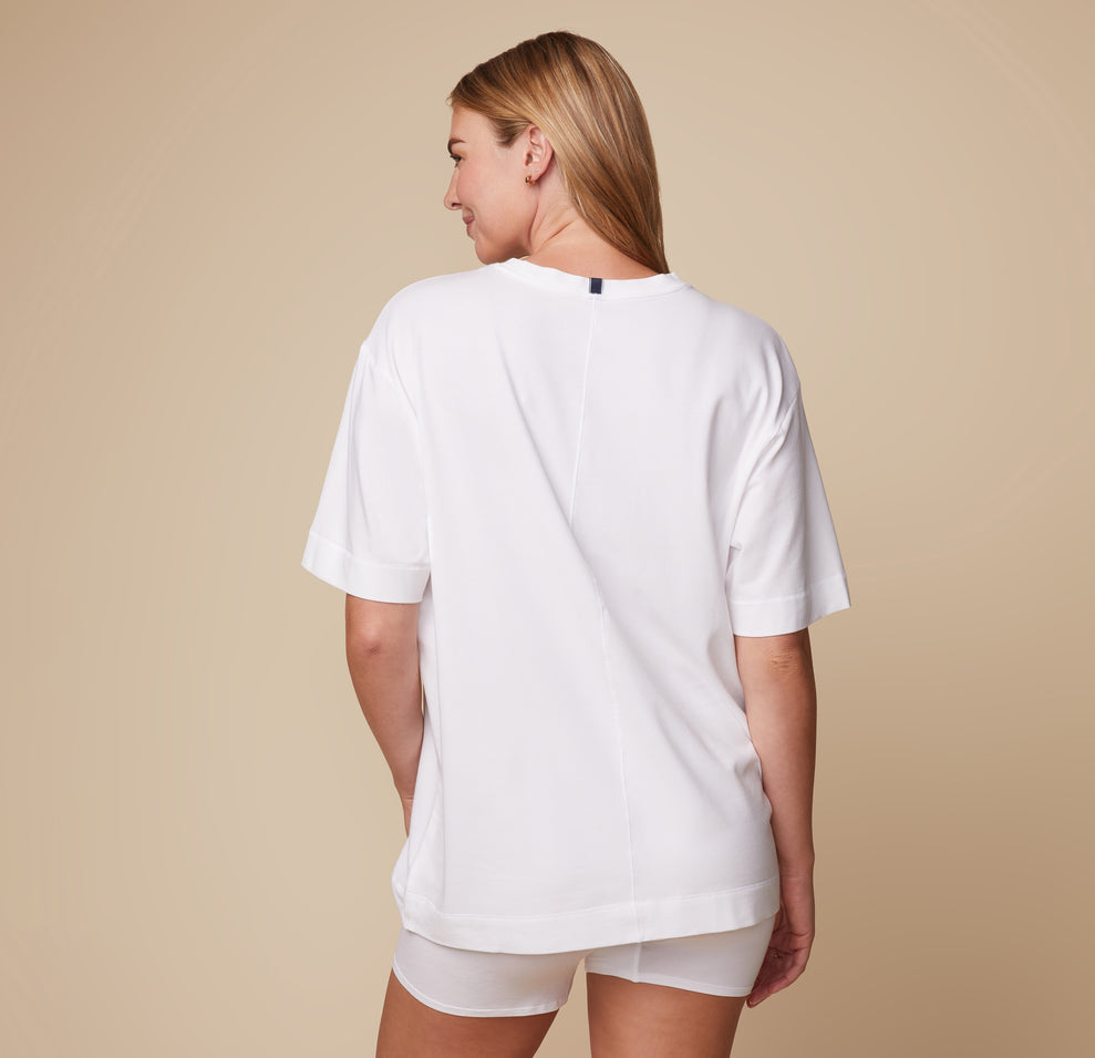 Back view of model Megan wearing the Cloud Cotton Tee in White and Cloud Cotton Logo Boxer Brief in White, showcasing the relaxed design from behind.