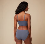 Back view of the model showcasing the Cloud Cotton Triangle Bralette and matching bottom in Slate. The image highlights the bralette’s adjustable straps and the comfortable fit of the bottom.