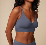 Close-up of the model’s upper body, focusing on the Cloud Cotton Triangle Bralette in Slate. The shot emphasizes the soft fabric and the triangular cut.