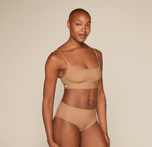 Woman wearing the Bliss Scoop Bralette in the color Tan