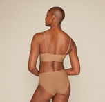 Woman wearing the Bliss Scoop Bralette in the color Tan
