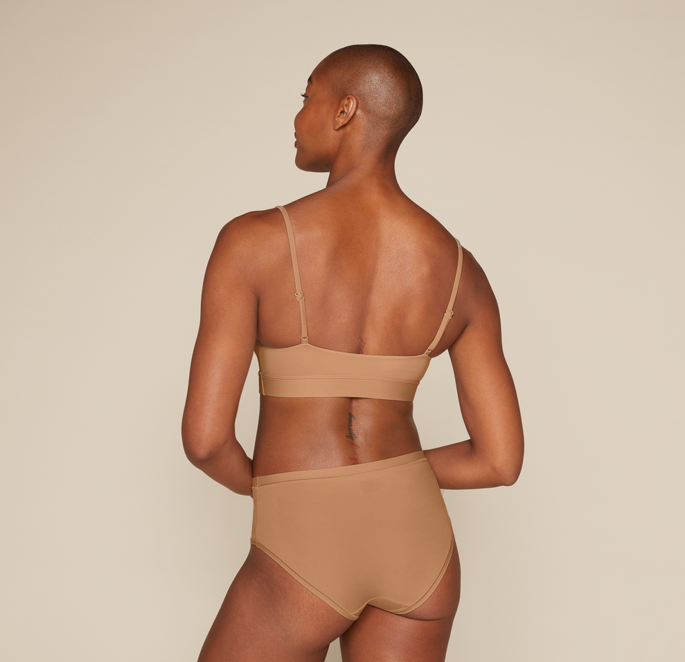 Woman wearing the Bliss Scoop Bralette in the color Tan
