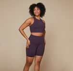 Model wearing the Flex Racerback Tank in the color Mulberry with the matching Flex High Rise Bikeshort.