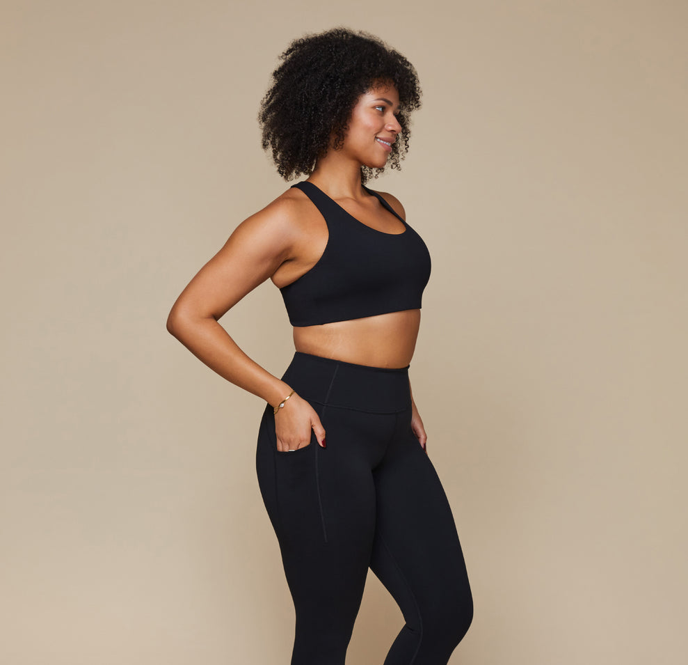 Model wearing the Flex Crossback Convertible Sports Bra and matching Flex High Rise Leggings in Black. 