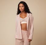 Model Ally wearing the Pima PJ Longsleeve in Bellini, left unbuttoned to reveal the Luxe Triangle Bralette in Pearl. The soft, relaxed fit of the pajama set is highlighted.